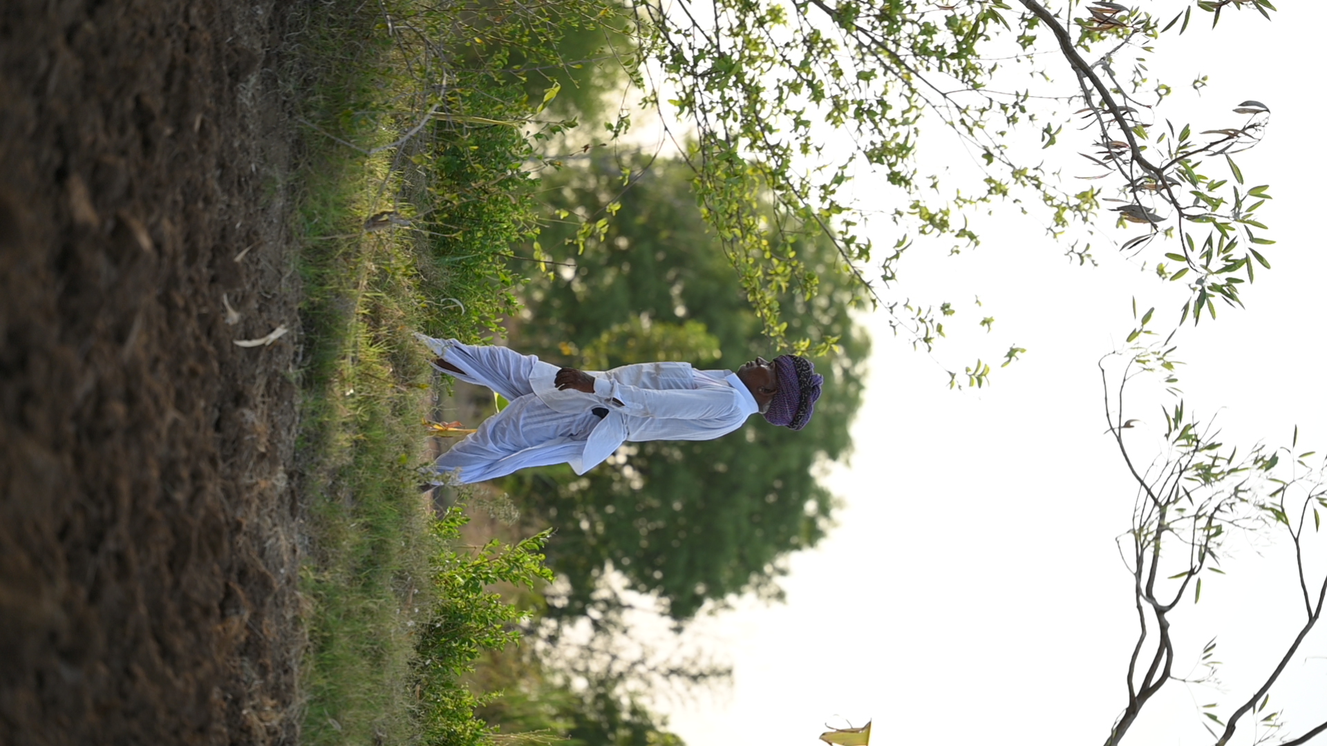 A farmer walking through the growing landscape at Dasot Farm